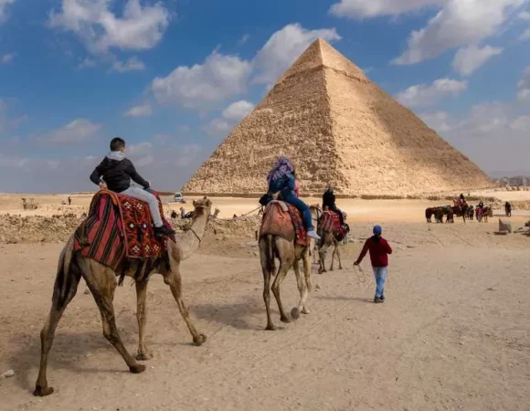 Camel ride trip at Giza Pyramids During Sunrise or Sunset
